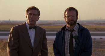Movie still from “Awakenings” (1990), directed by Penny Marshall – A couple of men standing next to each other in a field; Close Up shot, Low angle