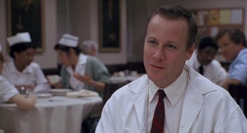 Movie still from “Awakenings” (1990), directed by Penny Marshall – A man wearing a white shirt and a red neck tie; Close Up shot, Low angle