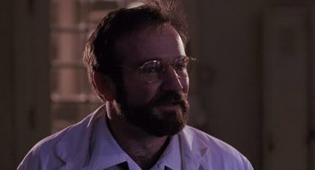 Movie still from “Awakenings” (1990), directed by Penny Marshall – A person with a beard wearing glasses; Close Up shot, Low angle