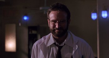 Movie still from “Awakenings” (1990), directed by Penny Marshall – A man with a beard wearing a white shirt and tie; Close Up shot, Low angle