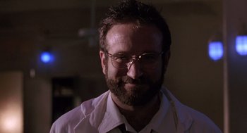 Movie still from “Awakenings” (1990), directed by Penny Marshall – A man with a beard and glasses smiling for the camera; Close Up shot, Low angle