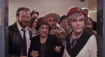 Movie still from “Awakenings” (1990), directed by Penny Marshall – A group of people wearing hats and posing for a picture; Medium shot, High angle