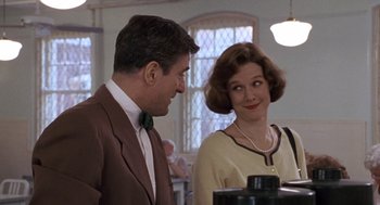 Movie still from “Awakenings” (1990), directed by Penny Marshall – A man and a woman standing next to each other in a room; Medium shot, Over the shoulder angle