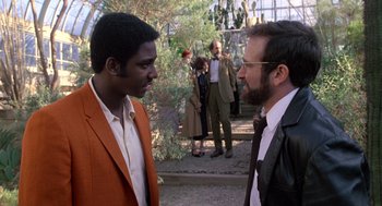 Movie still from “Awakenings” (1990), directed by Penny Marshall – Two men are talking to each other in a park; Medium shot, Over the shoulder angle