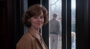 Movie still from “Awakenings” (1990), directed by Penny Marshall – A woman standing in front of a window with people in the background; Close Up shot, Over the shoulder angle