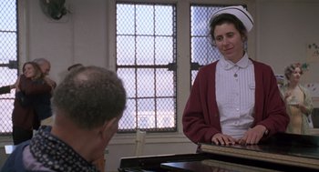 Movie still from “Awakenings” (1990), directed by Penny Marshall – An older man and a young woman playing a piano; Medium shot, Over the shoulder angle
