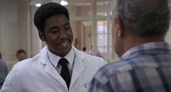 Movie still from “Awakenings” (1990), directed by Penny Marshall – A man wearing a lab coat talking to another man; Close Up shot, Over the shoulder angle