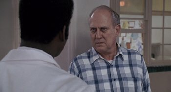 Movie still from “Awakenings” (1990), directed by Penny Marshall – An older man is looking at a younger man in the mirror; Close Up shot, Over the shoulder angle