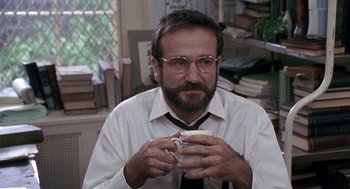 Movie still from “Awakenings” (1990), directed by Penny Marshall – A man in a white shirt and tie holding a sandwich; Close Up shot, Over the shoulder angle