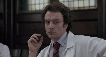 Movie still from “Awakenings” (1990), directed by Penny Marshall – A man in a white lab coat holding a cell phone; Close Up shot, Low angle