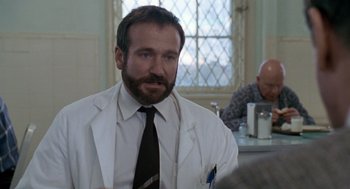 Movie still from “Awakenings” (1990), directed by Penny Marshall – A man wearing a white lab coat and a tie; Close Up shot, Over the shoulder angle
