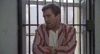 Movie still from “Awakenings” (1990), directed by Penny Marshall – A man in a striped jacket sitting in front of a window; Medium shot, High angle