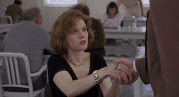 Movie still from “Awakenings” (1990), directed by Penny Marshall – A woman in a black shirt shaking hands with a man; Close Up shot, Over the shoulder angle
