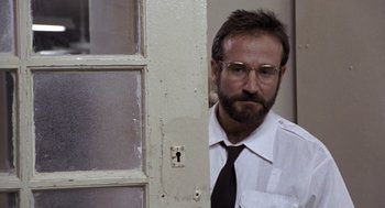 Movie still from “Awakenings” (1990), directed by Penny Marshall – A man with a beard wearing a white shirt and a tie; Close Up shot, Low angle