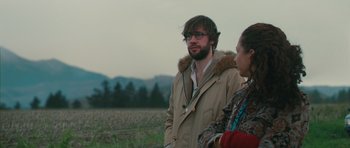 Movie still from “Away We Go” (2009), directed by Sam Mendes – A man and a woman are standing in a field; Medium shot, Over the shoulder angle