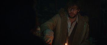 Movie still from “Away We Go” (2009), directed by Sam Mendes – A man holding a lit candle in a dark room; Medium shot, Over the shoulder angle