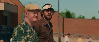 Movie still from “Away We Go” (2009), directed by Sam Mendes – Two men standing next to each other on a field; Close Up shot, Over the shoulder angle