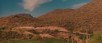 Movie still from “Away We Go” (2009), directed by Sam Mendes – A view of a road going through the desert; Extreme Wide shot, High angle