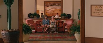 Movie still from “Away We Go” (2009), directed by Sam Mendes – A man and a woman sitting on a couch in a living room; Wide shot, Over the shoulder angle