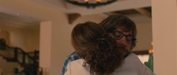 Movie still from “Away We Go” (2009), directed by Sam Mendes – A person wearing glasses and a ponytail; Close Up shot, Over the shoulder angle