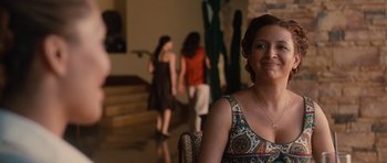Movie still from “Away We Go” (2009), directed by Sam Mendes – A woman sitting in front of two other women in a room; Close Up shot, Over the shoulder angle