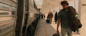 Movie still from “Away We Go” (2009), directed by Sam Mendes – A group of people walking along side of a train platform; Wide shot, Over the shoulder angle