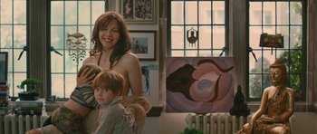 Movie still from “Away We Go” (2009), directed by Sam Mendes – A woman standing next to a child in a room; Medium shot, Over the shoulder angle