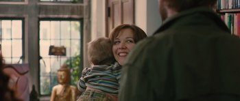 Movie still from “Away We Go” (2009), directed by Sam Mendes – A woman holding a baby in her arms; Medium shot, Over the shoulder angle