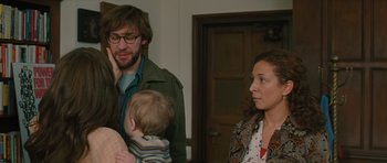 Movie still from “Away We Go” (2009), directed by Sam Mendes – A man and a woman with a baby in a room; Medium shot, Over the shoulder angle