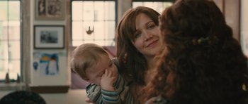 Movie still from “Away We Go” (2009), directed by Sam Mendes – A woman holding a child in her arms; Close Up shot, Over the shoulder angle