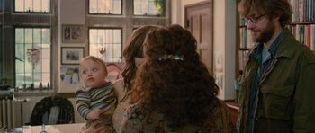 Movie still from “Away We Go” (2009), directed by Sam Mendes – A woman holding a baby in her arms; Medium shot, Over the shoulder angle