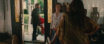 Movie still from “Away We Go” (2009), directed by Sam Mendes – A woman standing in front of two other people; Wide shot, Over the shoulder angle