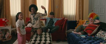 Movie still from “Away We Go” (2009), directed by Sam Mendes – Two young people sitting in a living room watching television; Wide shot, Over the shoulder angle