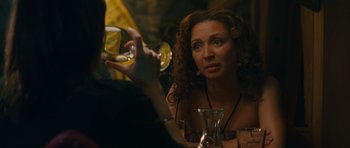 Movie still from “Away We Go” (2009), directed by Sam Mendes – A woman sitting in front of another woman holding a wine glass; Close Up shot, Over the shoulder angle