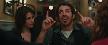 Movie still from “Away We Go” (2009), directed by Sam Mendes – A man with a beard is pointing to the sky; Close Up shot, Over the shoulder angle