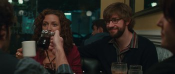 Movie still from “Away We Go” (2009), directed by Sam Mendes – A man and a woman sitting at a table with drinks; Medium shot, Over the shoulder angle