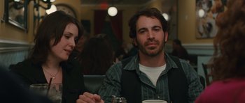 Movie still from “Away We Go” (2009), directed by Sam Mendes – A man sitting at a table in a restaurant; Close Up shot, Over the shoulder angle