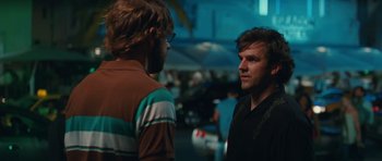 Movie still from “Away We Go” (2009), directed by Sam Mendes – Two men are standing in a parking lot; Close Up shot, Over the shoulder angle