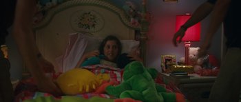Movie still from “Away We Go” (2009), directed by Sam Mendes – A little girl laying in a bed with stuffed animals; Medium shot, High angle