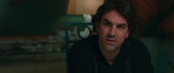 Movie still from “Away We Go” (2009), directed by Sam Mendes – A person sitting in a chair; Close Up shot, Over the shoulder angle