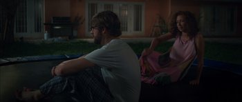 Movie still from “Away We Go” (2009), directed by Sam Mendes – A man and a woman sitting on the ground; Wide shot, Over the shoulder angle