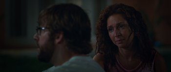 Movie still from “Away We Go” (2009), directed by Sam Mendes – A woman with curly red hair is looking at a man; Close Up shot, Over the shoulder angle