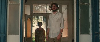 Movie still from “Away We Go” (2009), directed by Sam Mendes – A man and a woman standing next to each other in a room; Medium shot, Low angle