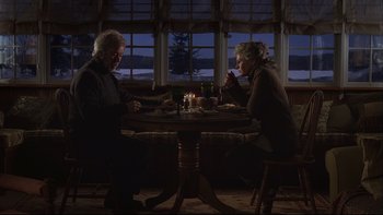 Movie still from “Away from Her” (2006), directed by Sarah Polley – A man and a woman sitting at a dinner table; Wide shot, High angle
