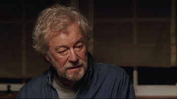 Movie still from “Away from Her” (2006), directed by Sarah Polley – An older man with white hair and a gray beard; Close Up shot, Over the shoulder angle
