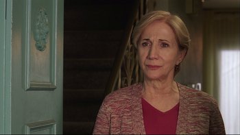 Movie still from “Away from Her” (2006), directed by Sarah Polley – An older woman standing in front of a staircase; Close Up shot, Over the shoulder angle
