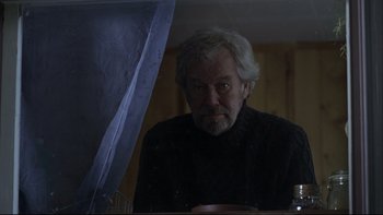Movie still from “Away from Her” (2006), directed by Sarah Polley – An older man looking at the reflection of himself in a mirror; Medium shot, Low angle