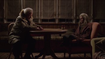 Movie still from “Away from Her” (2006), directed by Sarah Polley – A man and a woman sitting at a table in a room; Medium shot, Over the shoulder angle