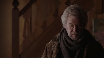 Movie still from “Away from Her” (2006), directed by Sarah Polley – An older man wearing a sweater and a scarf; Medium shot, Low angle