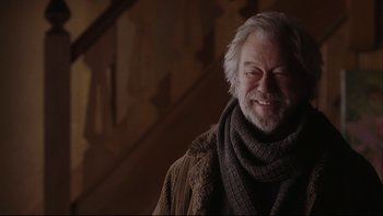 Movie still from “Away from Her” (2006), directed by Sarah Polley – An older man wearing a sweater and a scarf; Close Up shot, Low angle